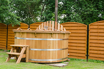 Image showing modern wooden water hot tub with stairs outdoor 