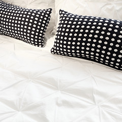 Image showing White bed linen with black cushions