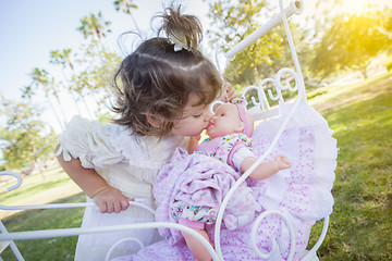 Image showing Adorable Young Baby Girl Playing with Baby Doll and Carriage