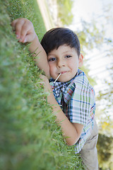 Image showing Young Boy Enjoying His Lollipop Outdoors Laying on Grass