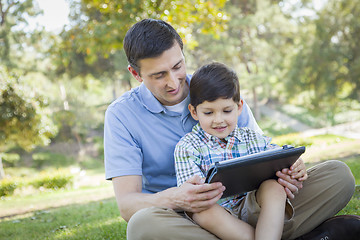 Image showing Handsome Mixed Race Father and Son Playing on Computer Tablet