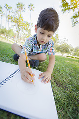 Image showing Cute Young Boy Drawing Outdoors on the Grass
