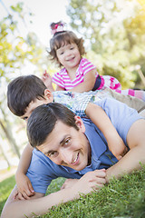 Image showing Young Son and Daughter Having Fun With Their Dad Outdoors