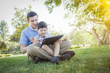 Image showing Handsome Mixed Race Father and Son Playing on Computer Tablet