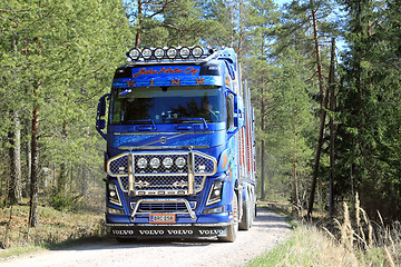 Image showing Blue Volvo FH16 750 Timber Truck on Forest Road