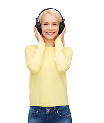 Image showing smiling young woman with headphones