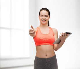 Image showing sporty woman with tablet pc computer