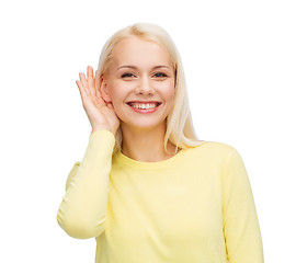 Image showing smiling young woman listening to gossip