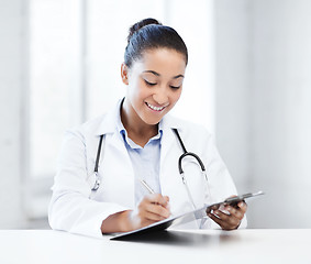 Image showing female doctor writing prescription