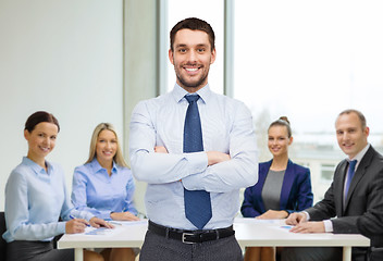 Image showing handsome businessman with crossed arms