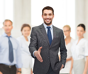 Image showing businessman with open hand ready for handshake