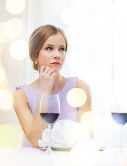 Image showing upset woman with glass of whine waiting for date