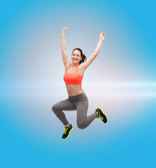 Image showing sporty teenage girl jumping in sportswear