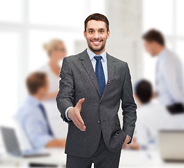 Image showing businessman with open hand ready for handshake