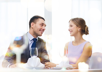 Image showing smiling couple looking at each other at restaurant