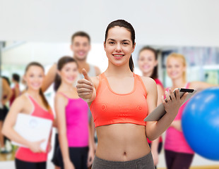 Image showing sporty woman with tablet pc computer