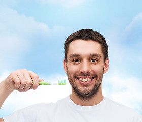 Image showing smiling young man with toothbrush