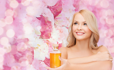 Image showing happy woman with oil bottle