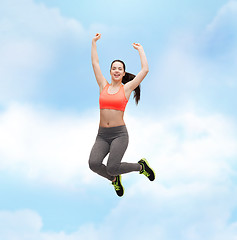 Image showing sporty teenage girl jumping in sportswear