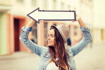 Image showing girl showing direction with arrow in the city