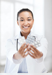 Image showing doctor with blister packs of pills