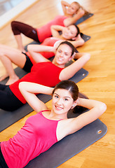 Image showing group of smiling women exercising in the gym