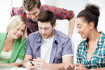 Image showing students looking at smartphone