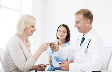 Image showing doctor giving tablets to patient in hospital