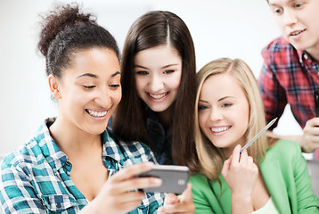 Image showing students looking at smartphone at school