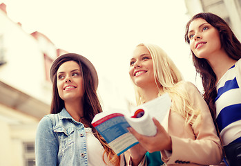 Image showing three beautiful girls with tourist book in city