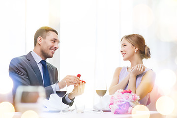 Image showing man proposing to his girlfriend at restaurant