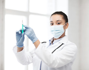 Image showing african doctor holding syringe with injection