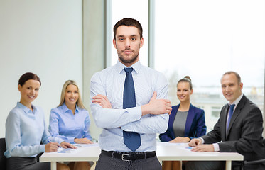 Image showing handsome businessman with crossed arms