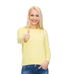 Image showing smiling girl in casual clothes showing thumbs up