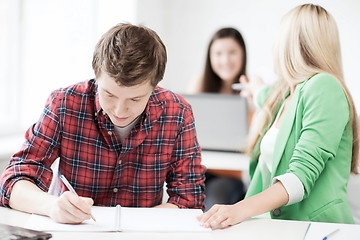 Image showing students writing something at school