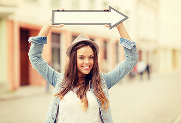 Image showing girl showing direction with arrow in the city