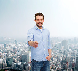 Image showing smiling man pointing finger at you