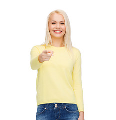 Image showing smiling woman pointing finger at you