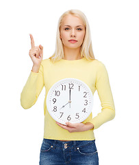 Image showing student with wall clock and finger up