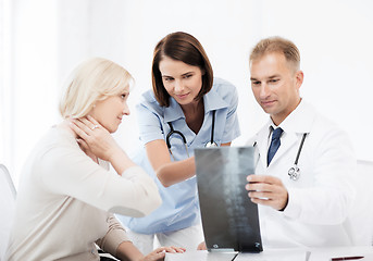 Image showing doctors with patient looking at x-ray