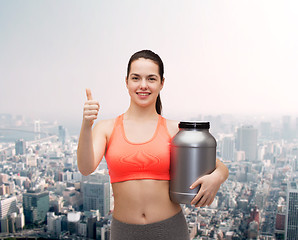 Image showing teenage girl with jar of protein showing thumbs up