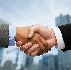 Image showing businessman and businesswoman shaking hands