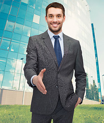 Image showing businessman with open hand ready for handshake