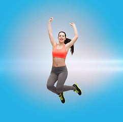 Image showing sporty teenage girl jumping in sportswear