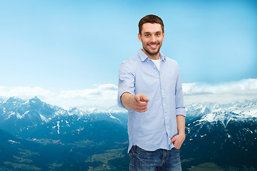 Image showing smiling man pointing finger at you