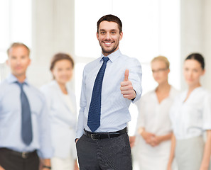 Image showing handsome businessman with crossed arms