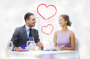 Image showing smiling couple looking at each other at restaurant