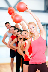 Image showing group of smiling people working out with ball