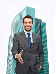 Image showing businessman with open hand ready for handshake