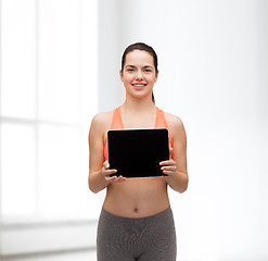 Image showing sporty woman with tablet pc blank screen